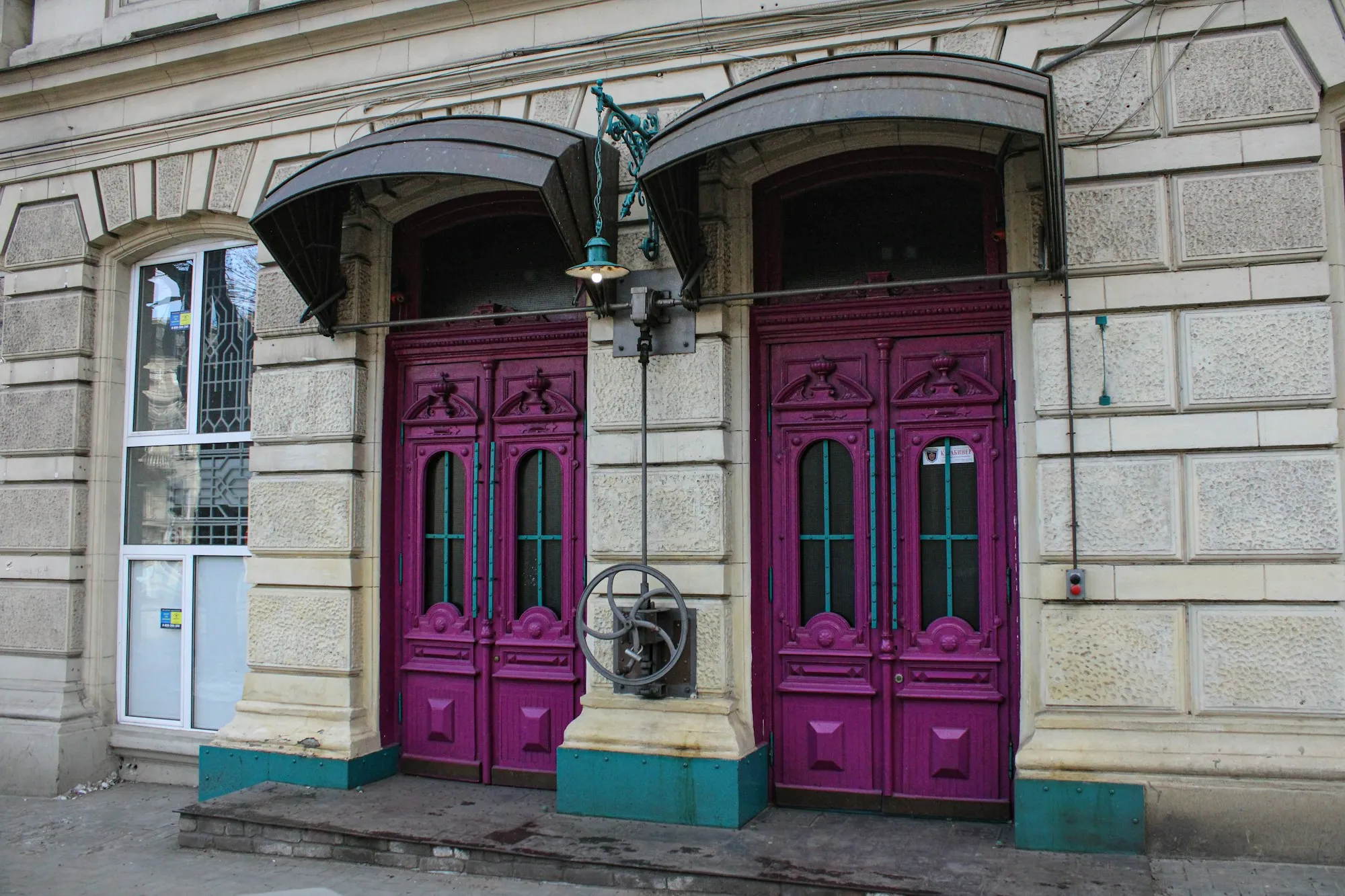 Two doors set side by side in the front of a building